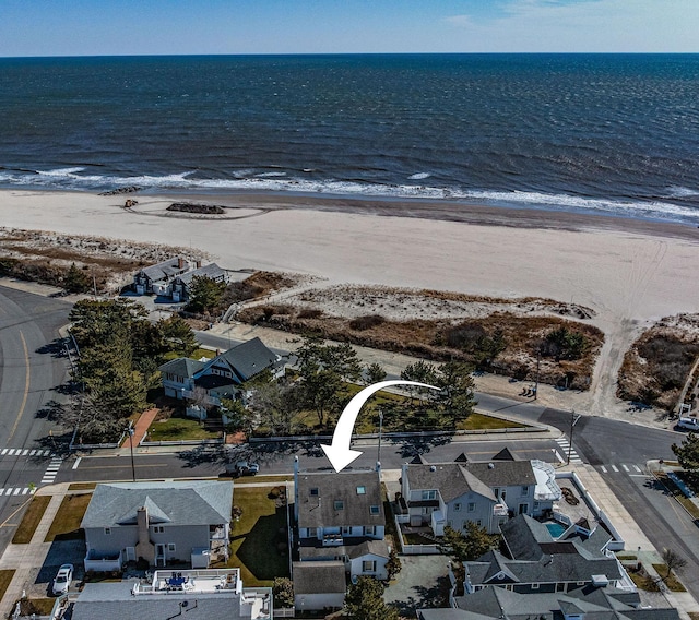 aerial view with a water view, a residential view, and a view of the beach