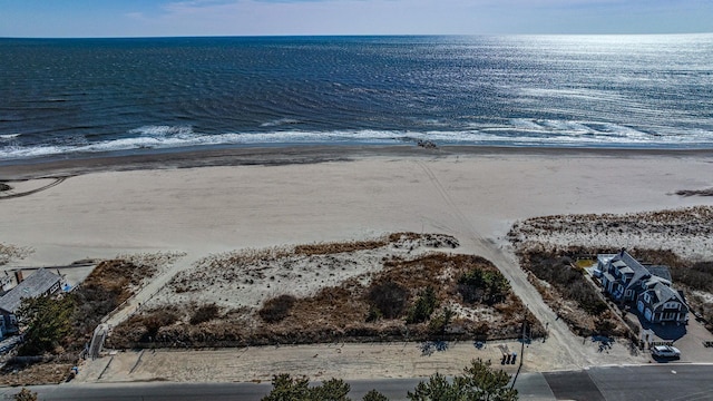 birds eye view of property featuring a beach view and a water view