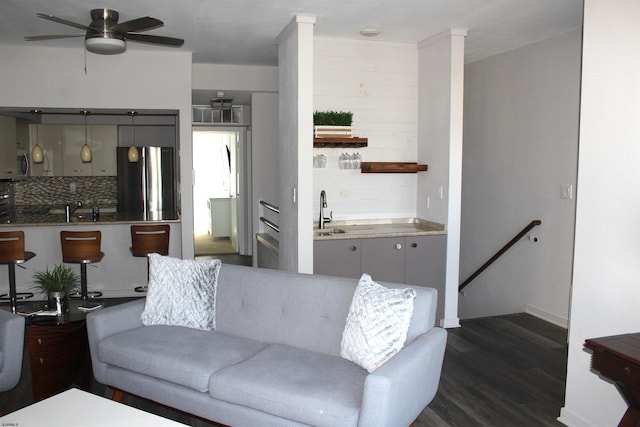 living area featuring dark wood finished floors and ceiling fan