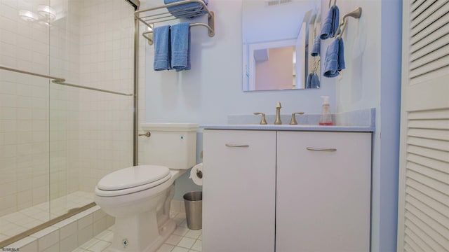 bathroom featuring toilet, visible vents, vanity, a shower stall, and tile patterned floors