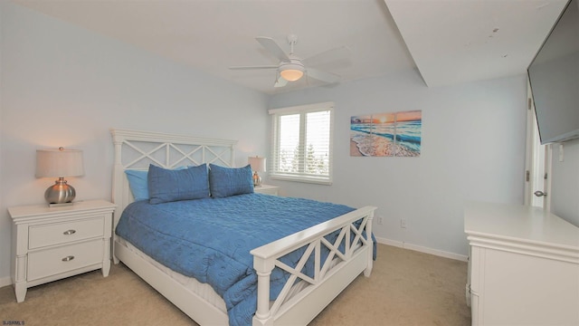 bedroom with light carpet, baseboards, and a ceiling fan