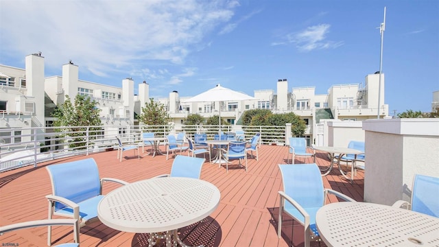 wooden deck with outdoor dining space and a view of city