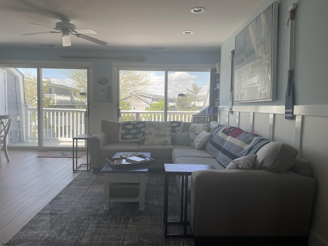 living room with a ceiling fan, wood finished floors, a wealth of natural light, and recessed lighting