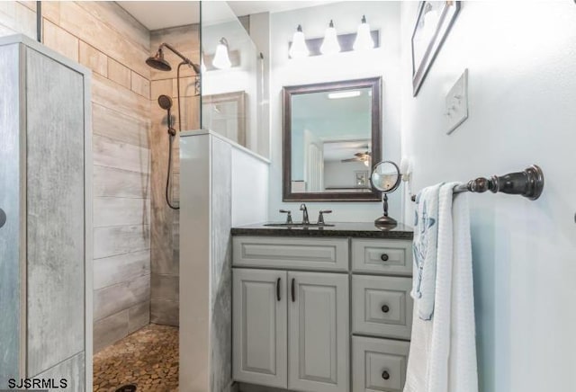 bathroom with a walk in shower and vanity