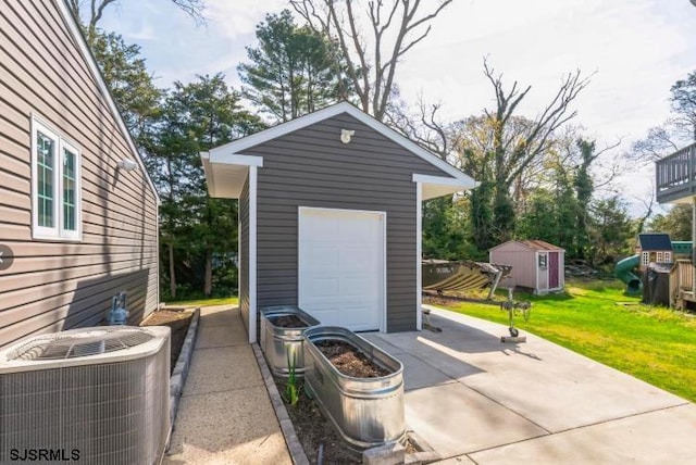 garage featuring central AC and driveway