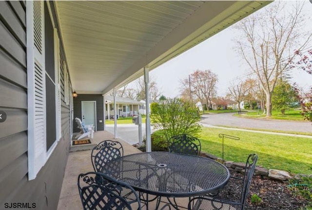 view of patio / terrace featuring a residential view and outdoor dining space