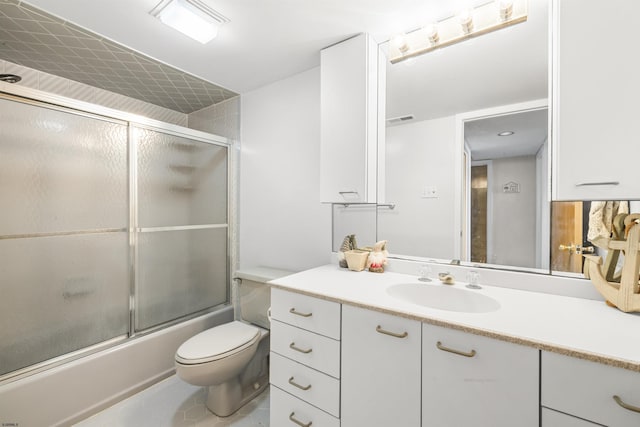 bathroom featuring visible vents, toilet, enclosed tub / shower combo, vanity, and tile patterned floors