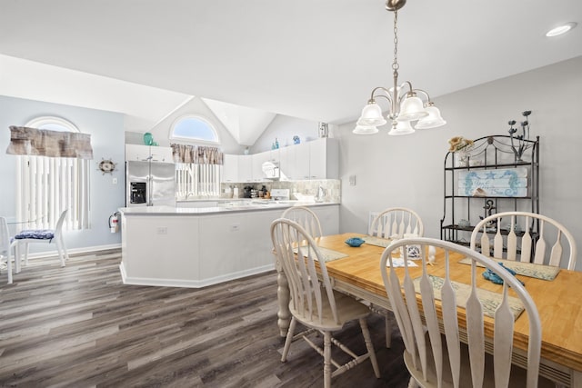 dining room featuring lofted ceiling, baseboards, dark wood-style floors, and a notable chandelier