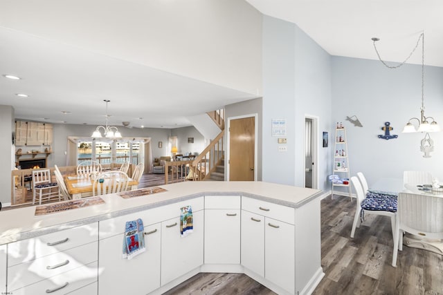 kitchen featuring decorative light fixtures, a notable chandelier, recessed lighting, light countertops, and wood finished floors