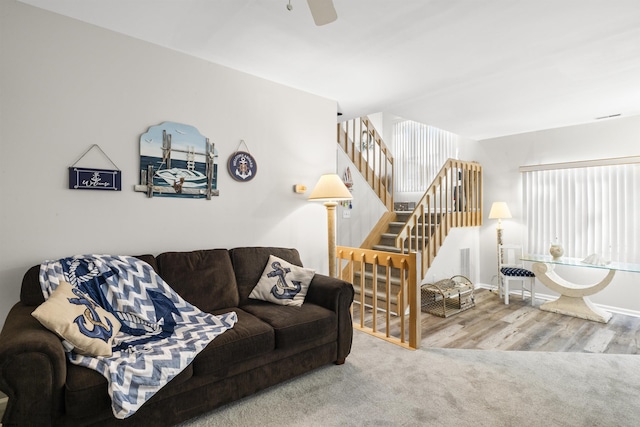 living room featuring stairway, wood finished floors, a ceiling fan, and baseboards