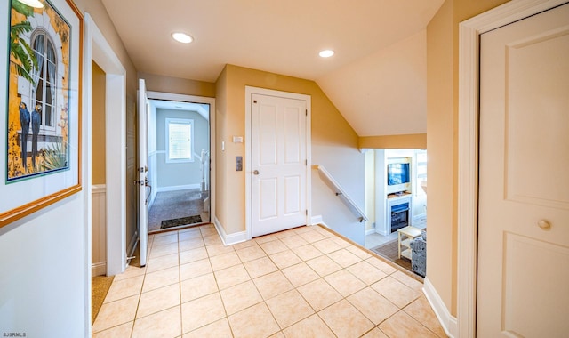 interior space with recessed lighting, baseboards, vaulted ceiling, and light tile patterned flooring