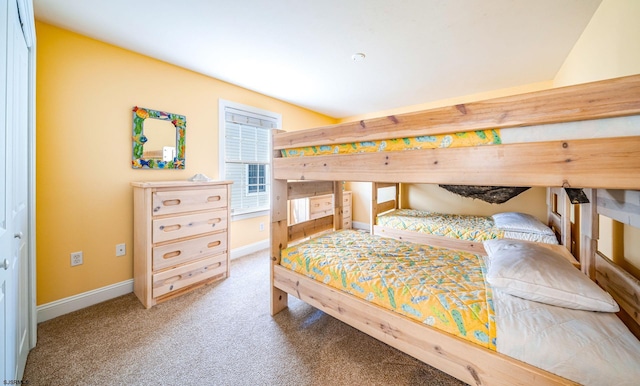 bedroom with carpet flooring and baseboards