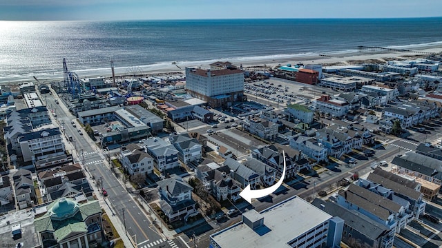 drone / aerial view featuring a water view and a view of the beach