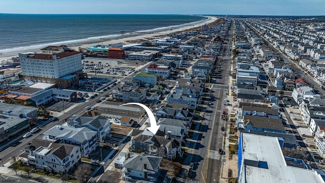 bird's eye view with a water view and a beach view