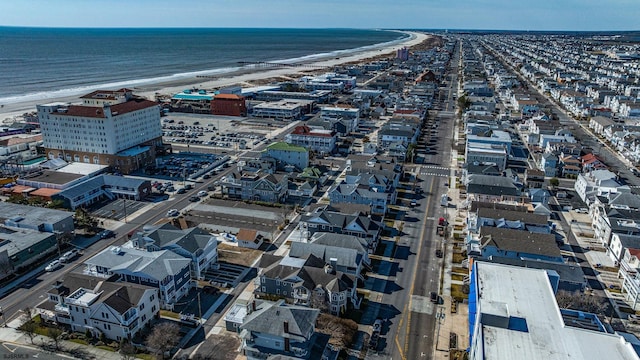 aerial view with a water view and a beach view