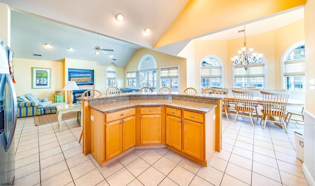 kitchen with light tile patterned floors, open floor plan, a wealth of natural light, and decorative light fixtures