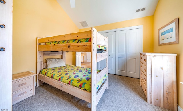 bedroom featuring vaulted ceiling, light carpet, and visible vents