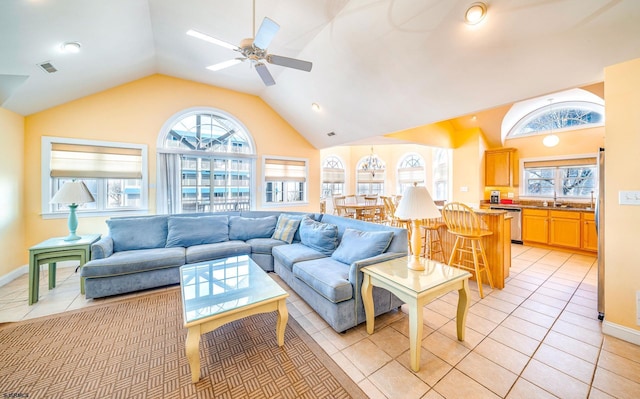 living area with lofted ceiling, light tile patterned floors, plenty of natural light, and visible vents