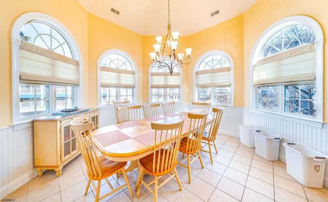 dining room featuring a chandelier, light tile patterned floors, wainscoting, and visible vents