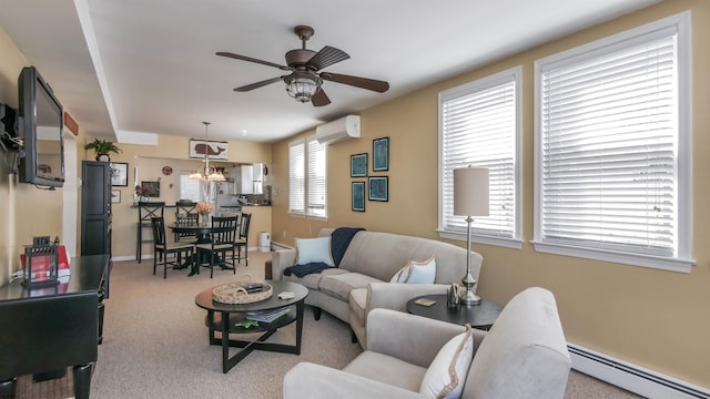 carpeted living room with a baseboard radiator, a wall unit AC, baseboards, and ceiling fan with notable chandelier