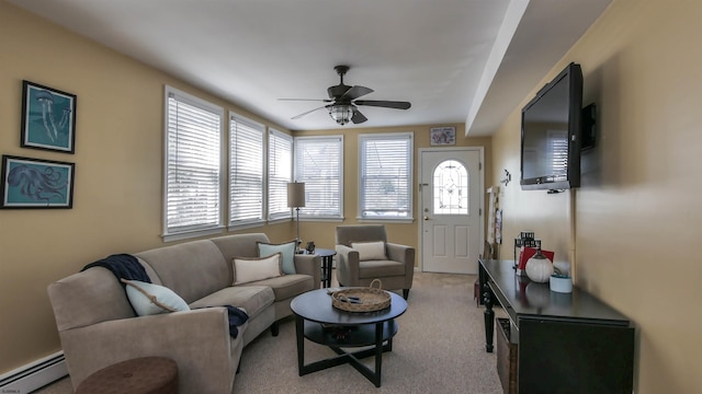 living area with a baseboard radiator, light colored carpet, and ceiling fan