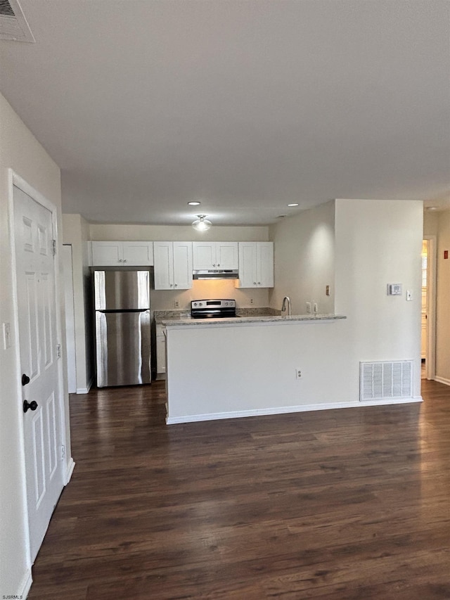 kitchen featuring under cabinet range hood, white cabinetry, visible vents, appliances with stainless steel finishes, and dark wood finished floors