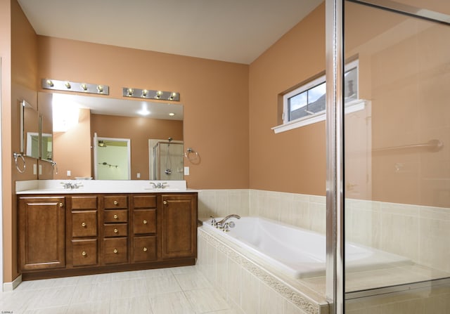 bathroom with double vanity, a stall shower, a sink, and a bath