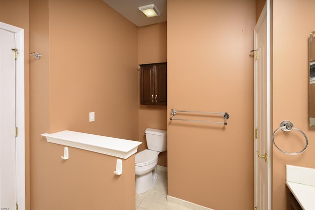 bathroom with tile patterned flooring, vanity, and toilet