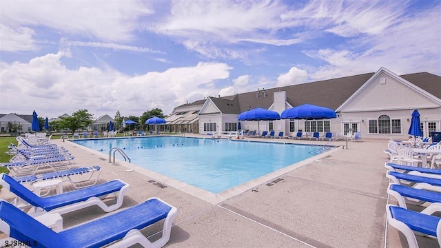 community pool featuring a patio area and fence