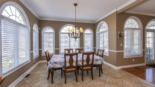 dining room featuring visible vents, baseboards, a notable chandelier, and ornamental molding