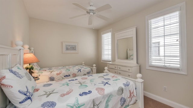 bedroom featuring a ceiling fan and baseboards