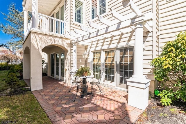 view of patio / terrace with french doors and a balcony