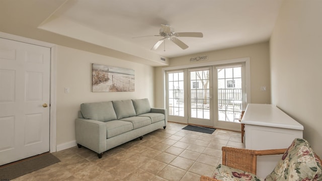 living room with light tile patterned floors, ceiling fan, and visible vents