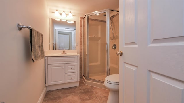 full bathroom with toilet, a stall shower, vanity, baseboards, and tile patterned floors