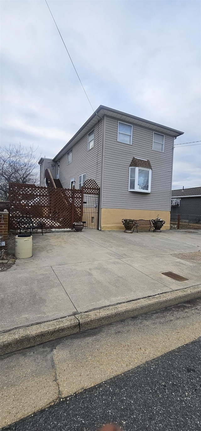 view of side of home featuring a gate