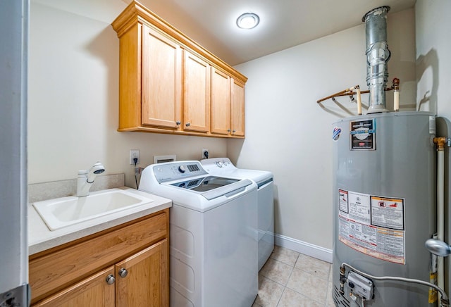 clothes washing area featuring cabinet space, light tile patterned floors, washer and dryer, water heater, and a sink