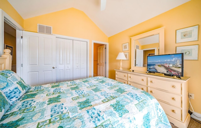 bedroom with vaulted ceiling, ceiling fan, a closet, and visible vents