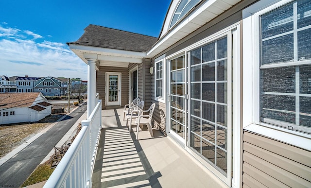 balcony featuring a residential view and a sunroom