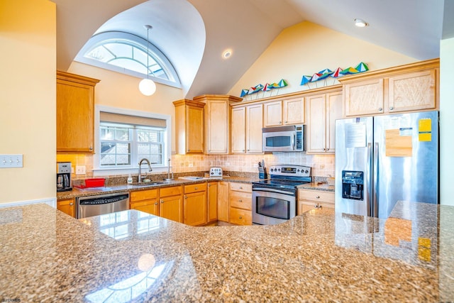 kitchen with high vaulted ceiling, stone counters, a sink, appliances with stainless steel finishes, and backsplash