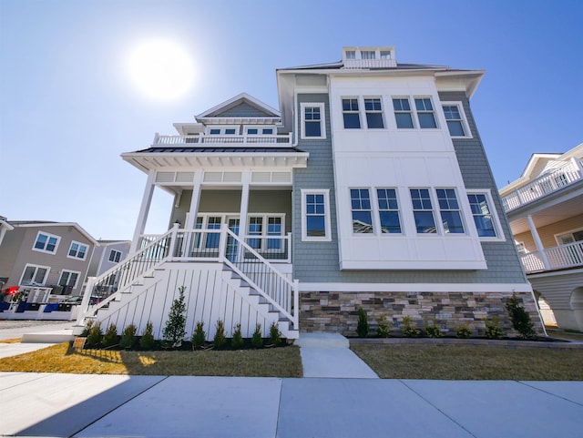 view of front of house with metal roof, stairs, a porch, and a standing seam roof