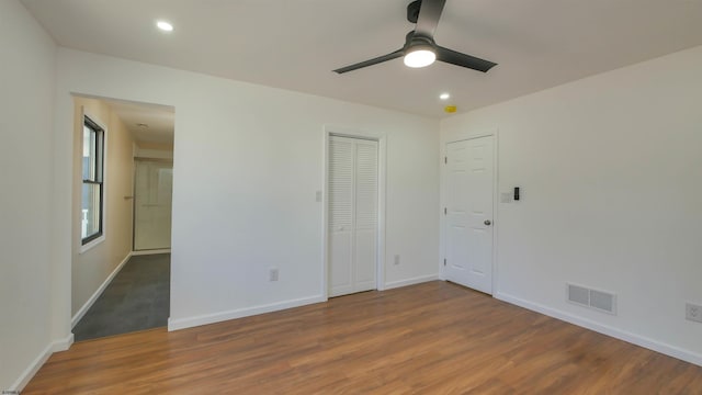 unfurnished bedroom with recessed lighting, wood finished floors, visible vents, and baseboards