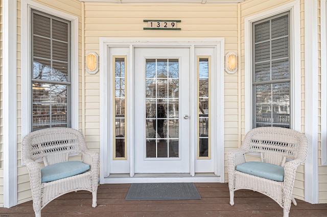 view of exterior entry featuring covered porch