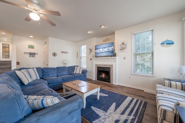 living room with ceiling fan, recessed lighting, wood finished floors, baseboards, and a tiled fireplace