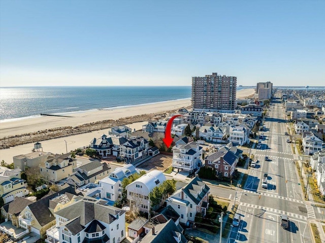 birds eye view of property featuring a view of the beach and a water view