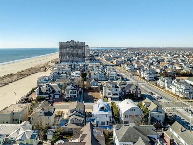 drone / aerial view with a residential view, a beach view, and a water view