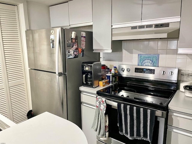 kitchen with under cabinet range hood, backsplash, appliances with stainless steel finishes, and white cabinets