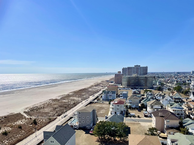 aerial view featuring a water view and a beach view