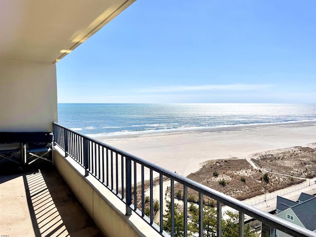 balcony with a view of the beach and a water view