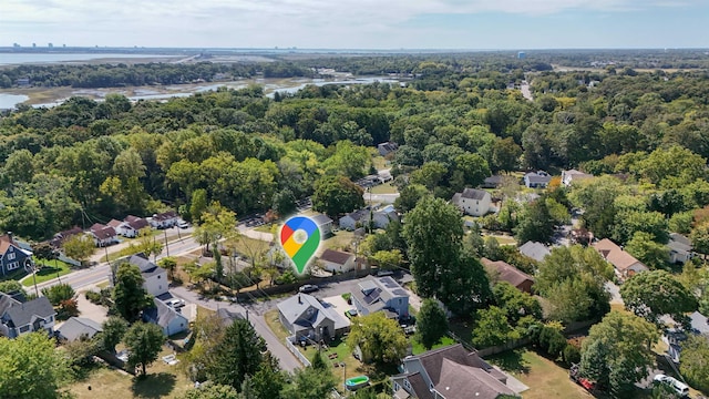 bird's eye view with a residential view, a wooded view, and a water view