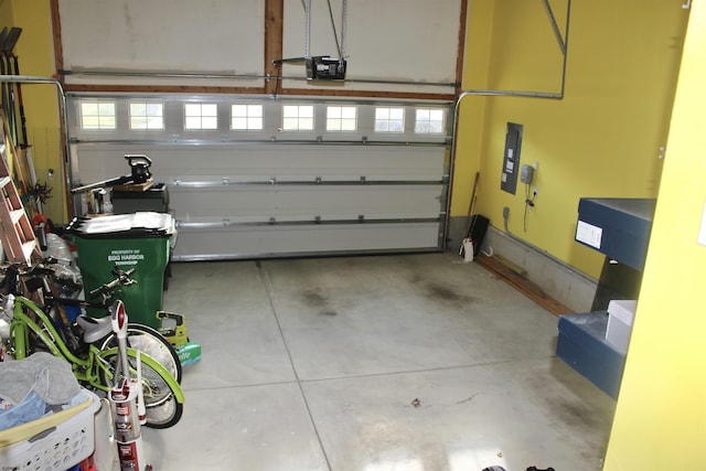 garage with baseboards and a garage door opener